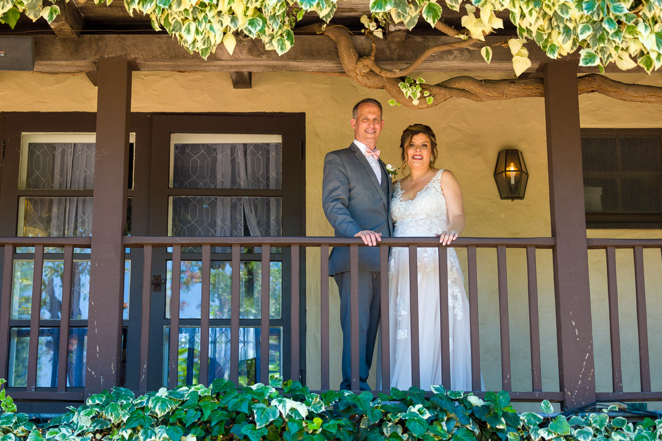A couple on a balcony at their wedding venue