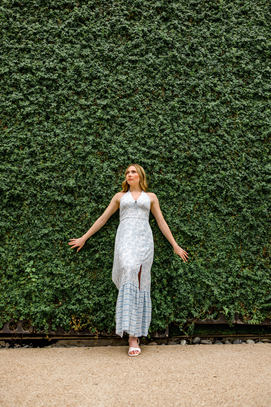 Confident senior portrait against greenery